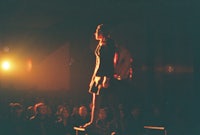 a woman standing on a platform in front of a crowd
